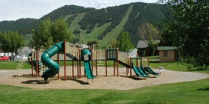 A large play area with mountains in  the background.